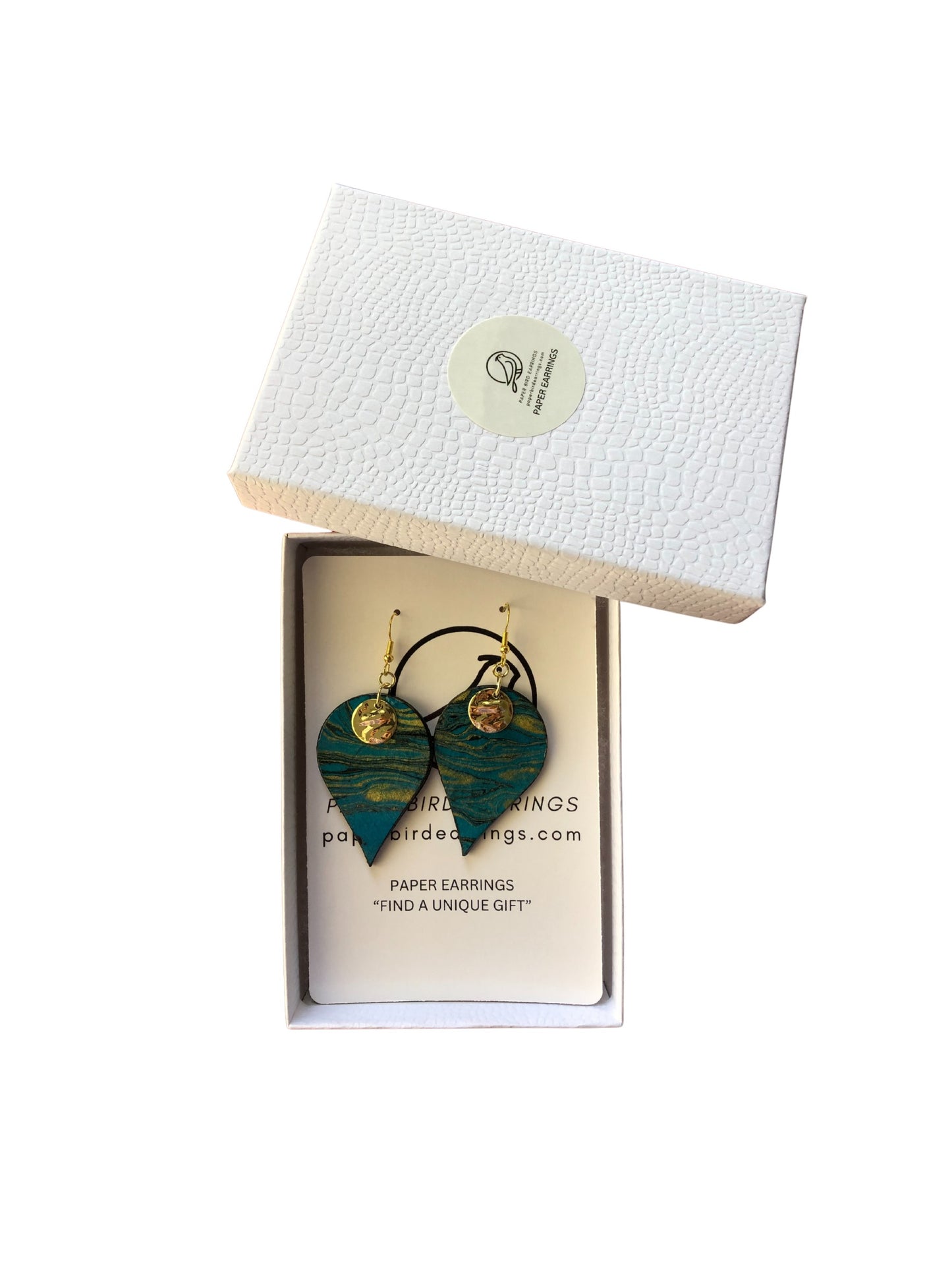 Green heart-shaped earrings in a branded box on a white background