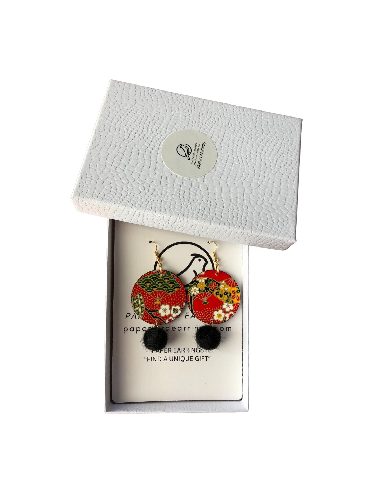 Pair of earrings in a decorative box with a white background