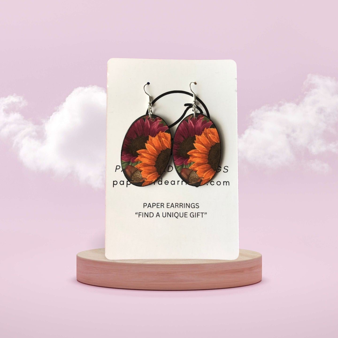 Earrings on a card with a pink background