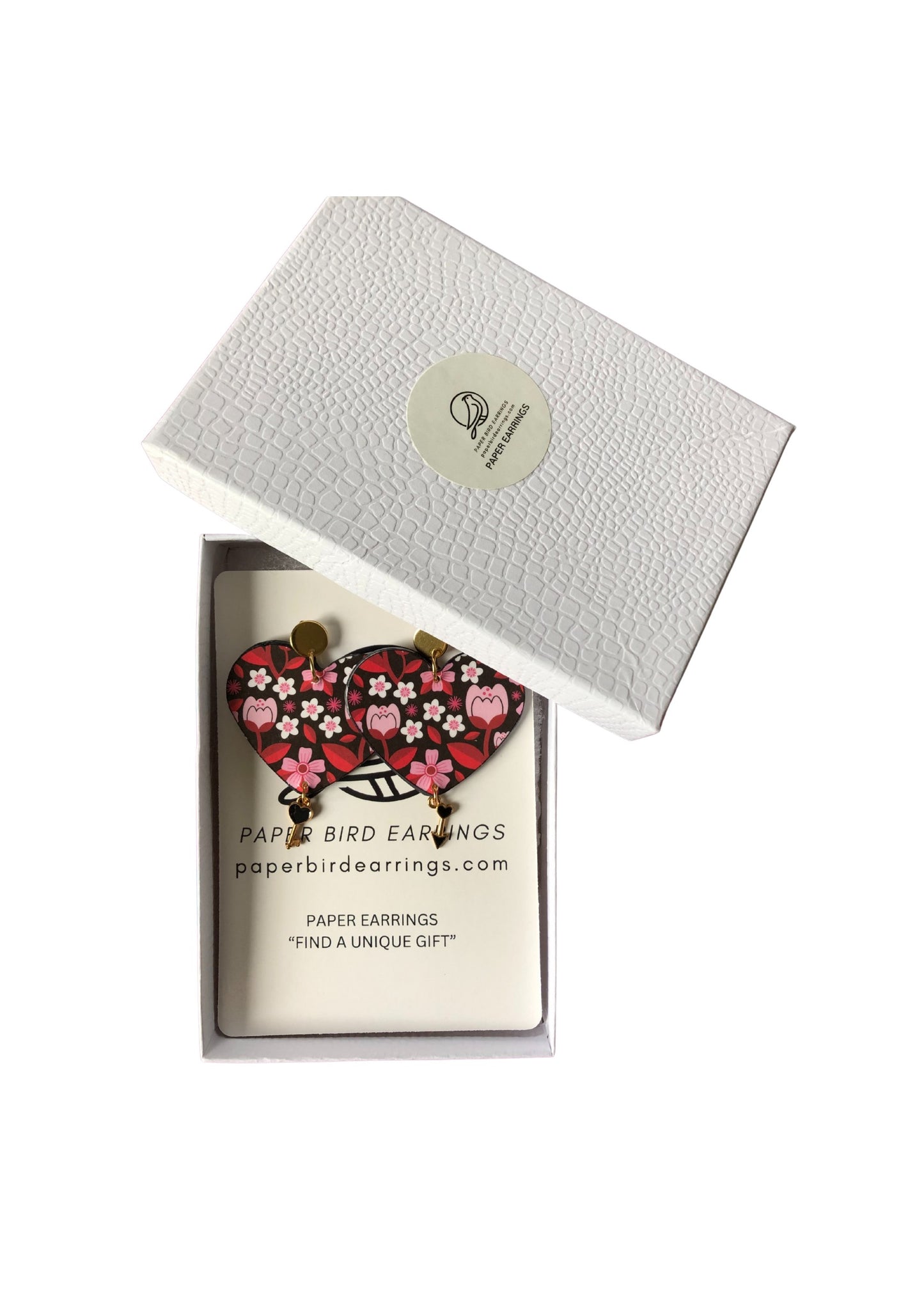 Heart-shaped earrings in a branded box with a white background