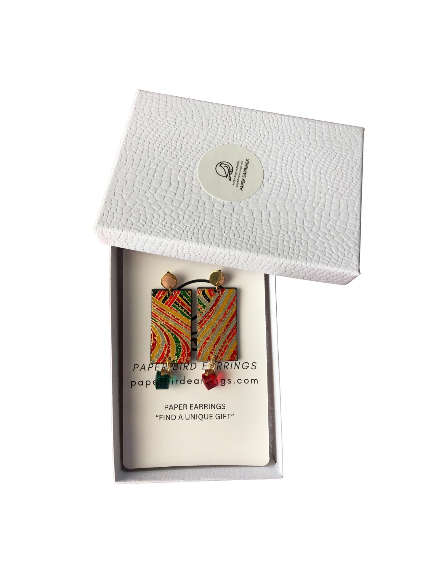 Colorful paper earrings in a white box with a brand label.