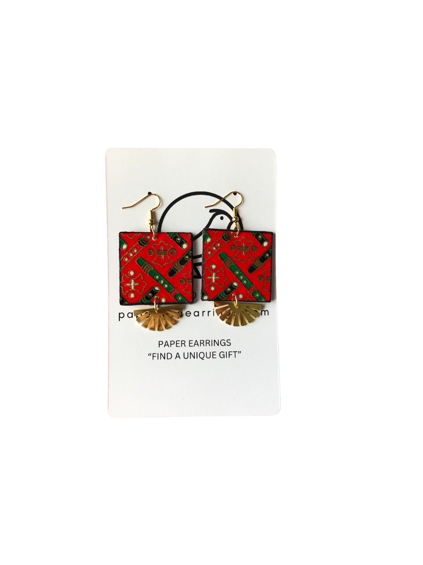 Red and green square earrings on a white card with text
