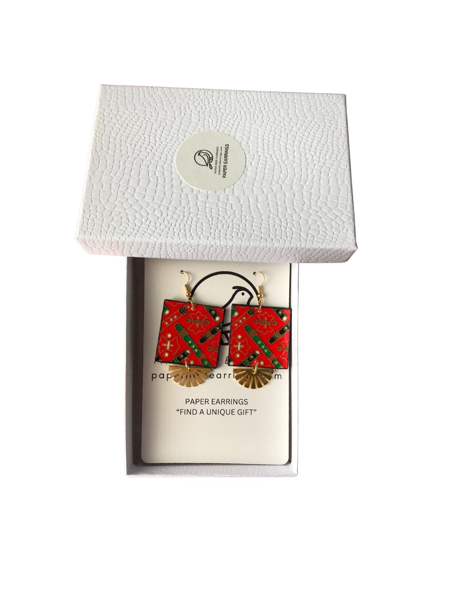 Red paper earrings in a white box with a visible brand label.