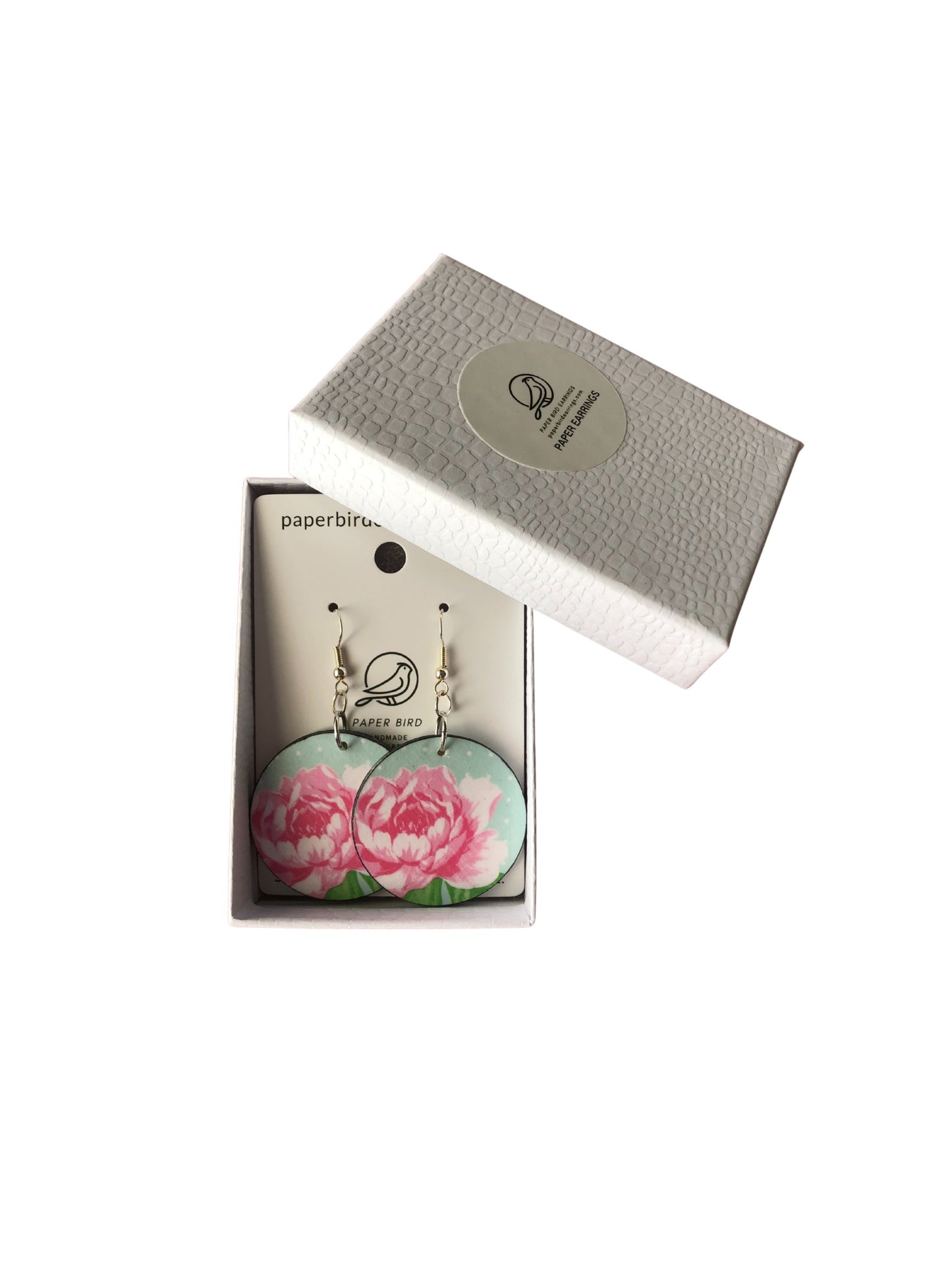 Floral earrings in a branded box on a white background