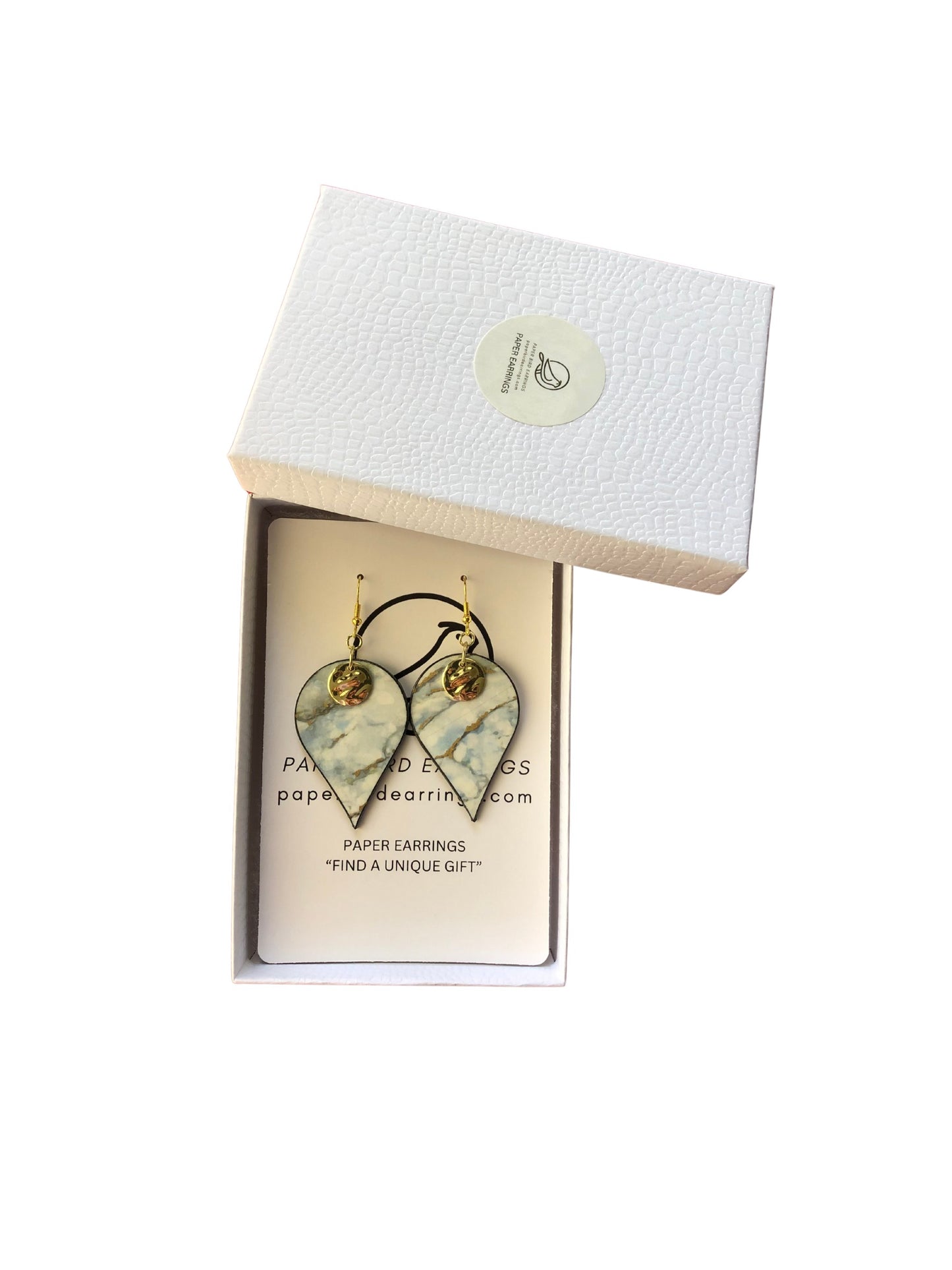 Heart-shaped earrings in a white box with a visible brand label.