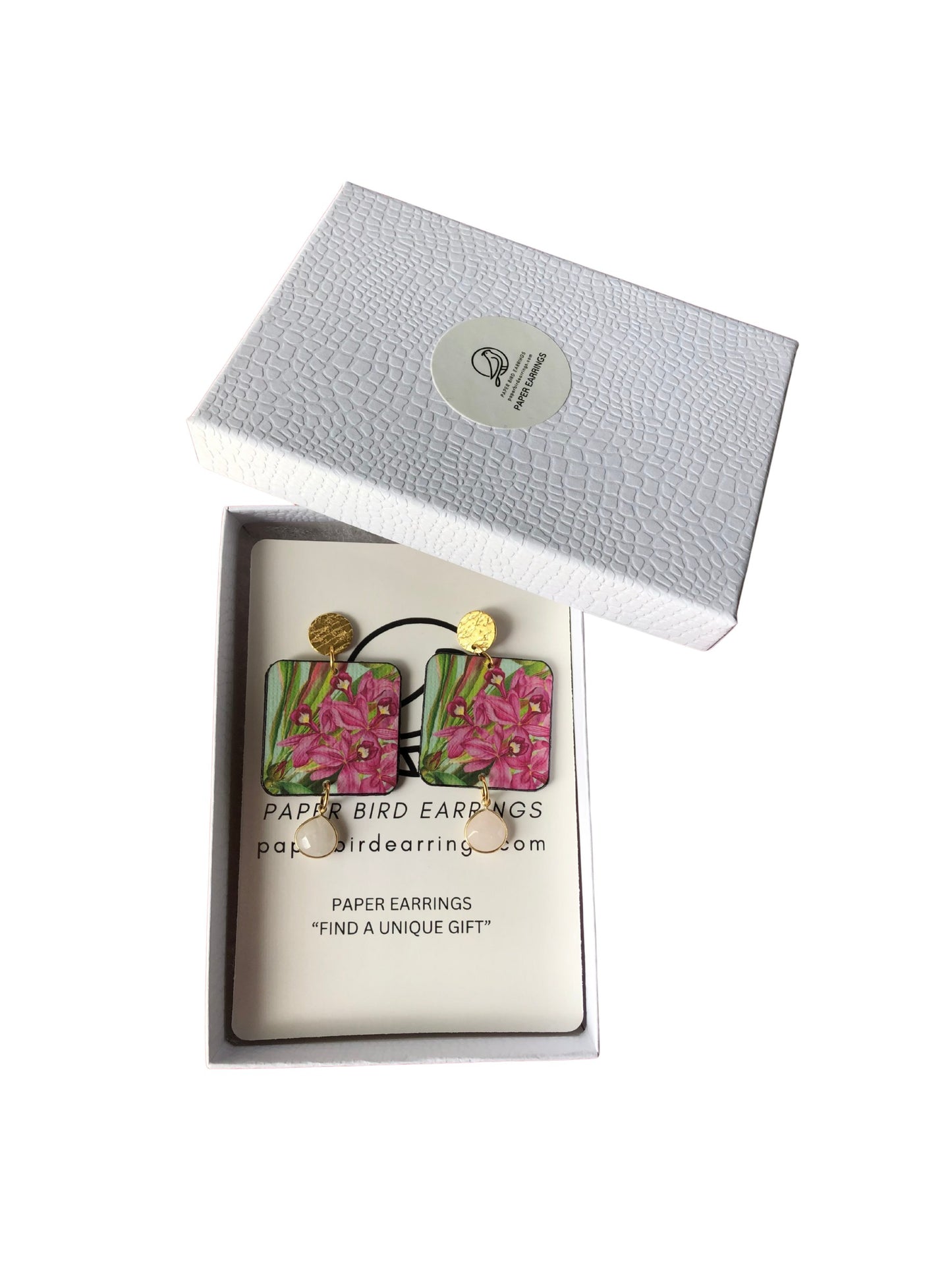 Floral paper earrings in a branded box on a white background