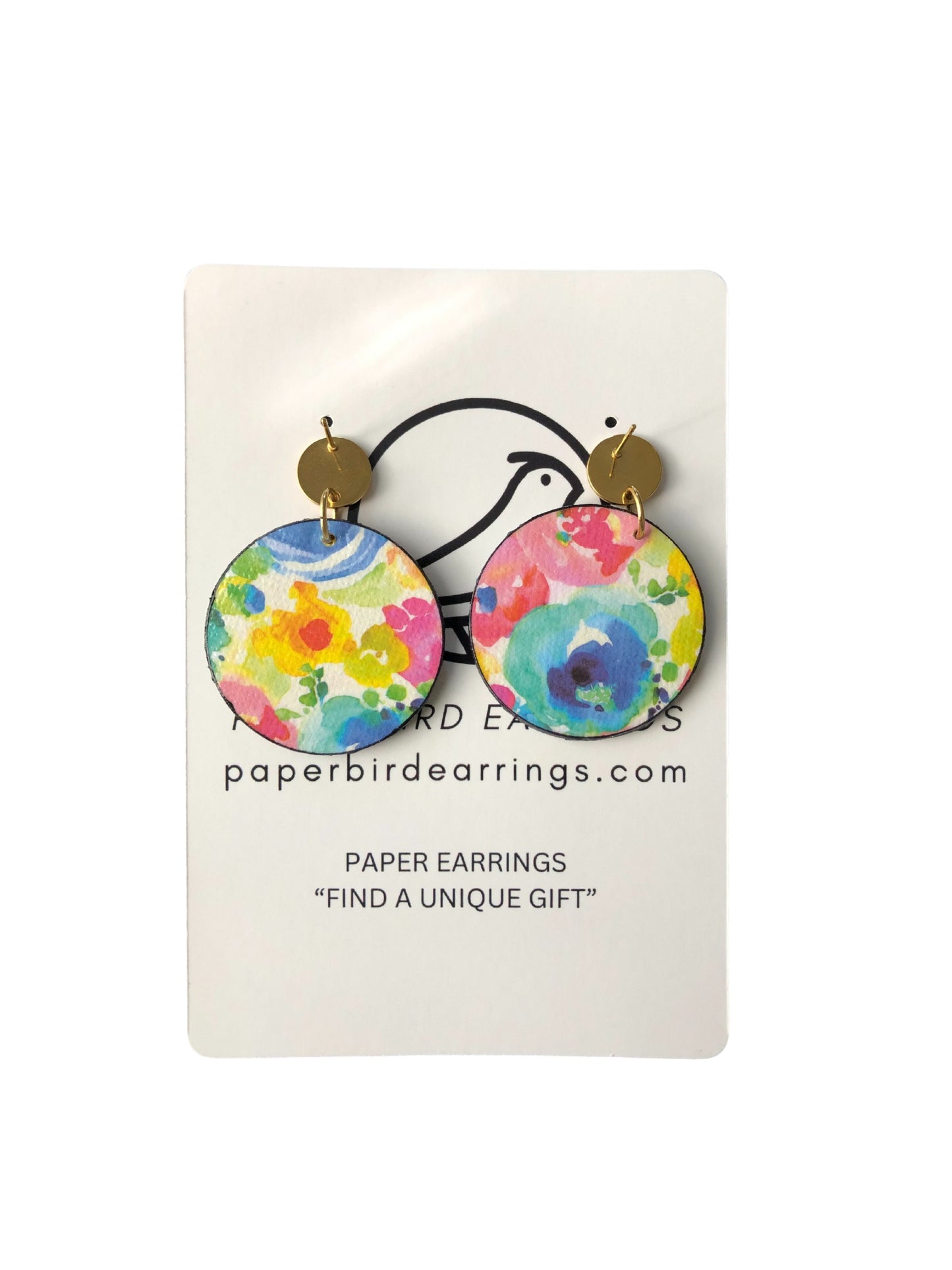 Colorful floral paper earrings on a white card with branding information.