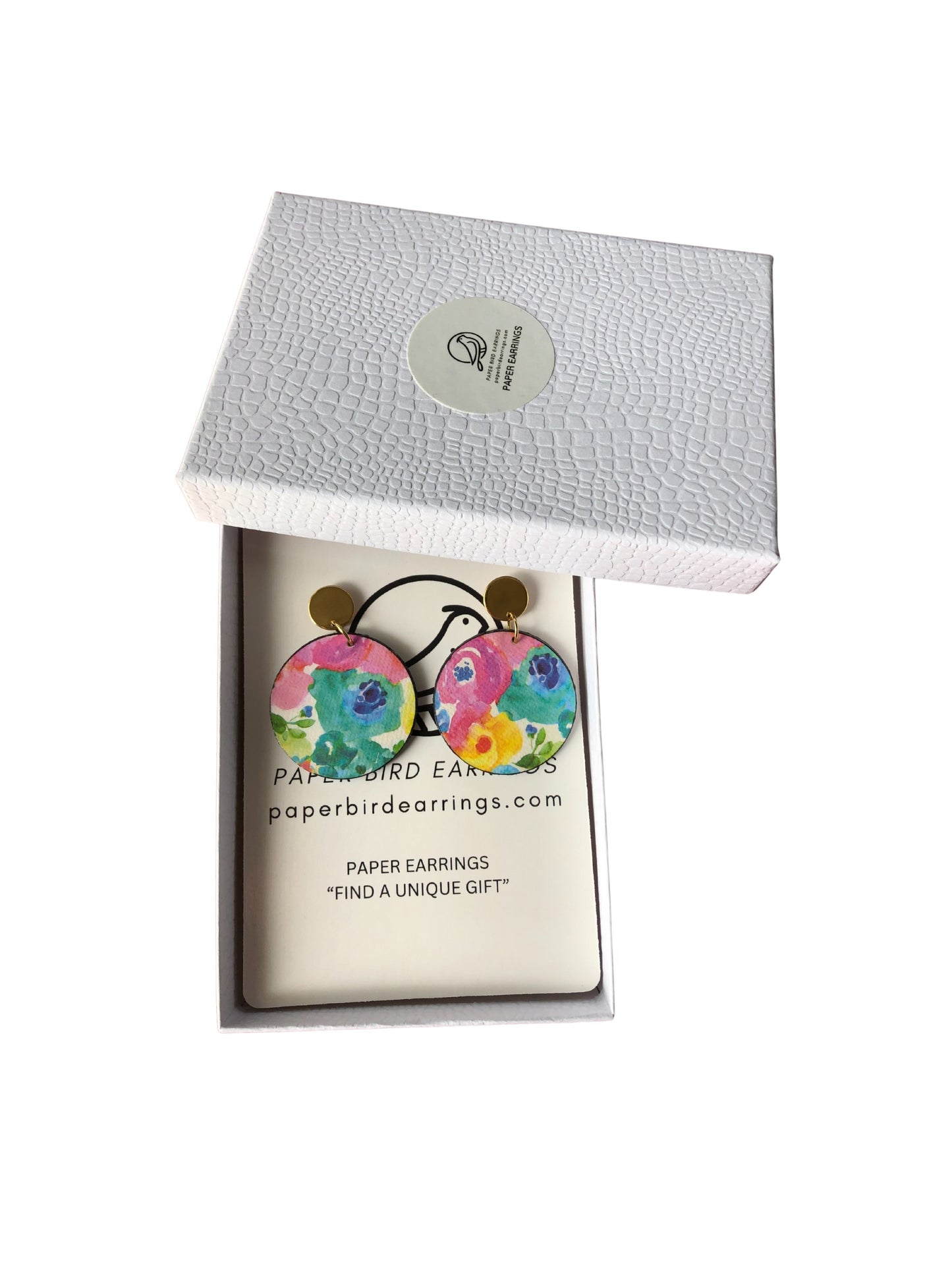 Colorful paper earrings in a branded box on a white background