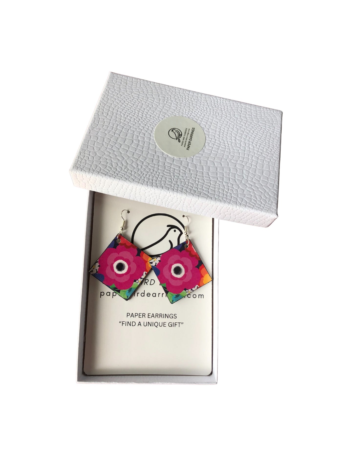 Floral paper earrings in a white box with a visible brand logo.