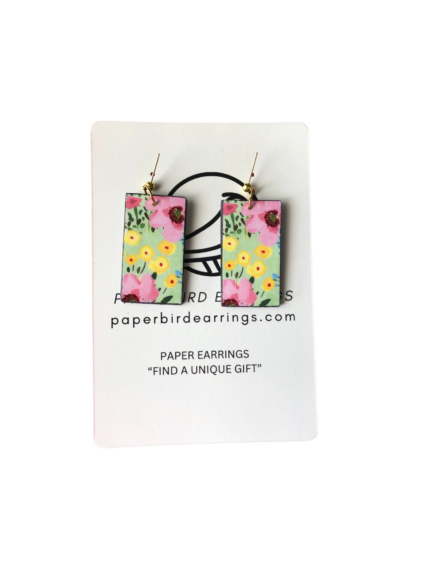 Floral paper earrings on a white card with branding text.