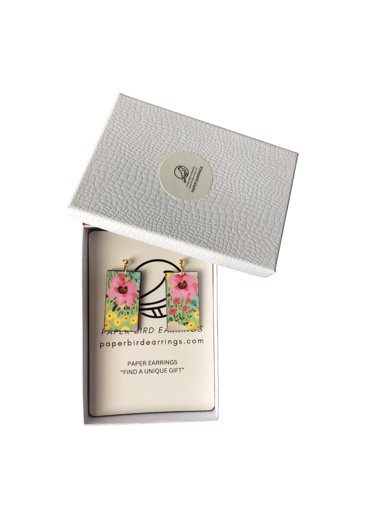 Floral paper earrings in a branded box on a white background