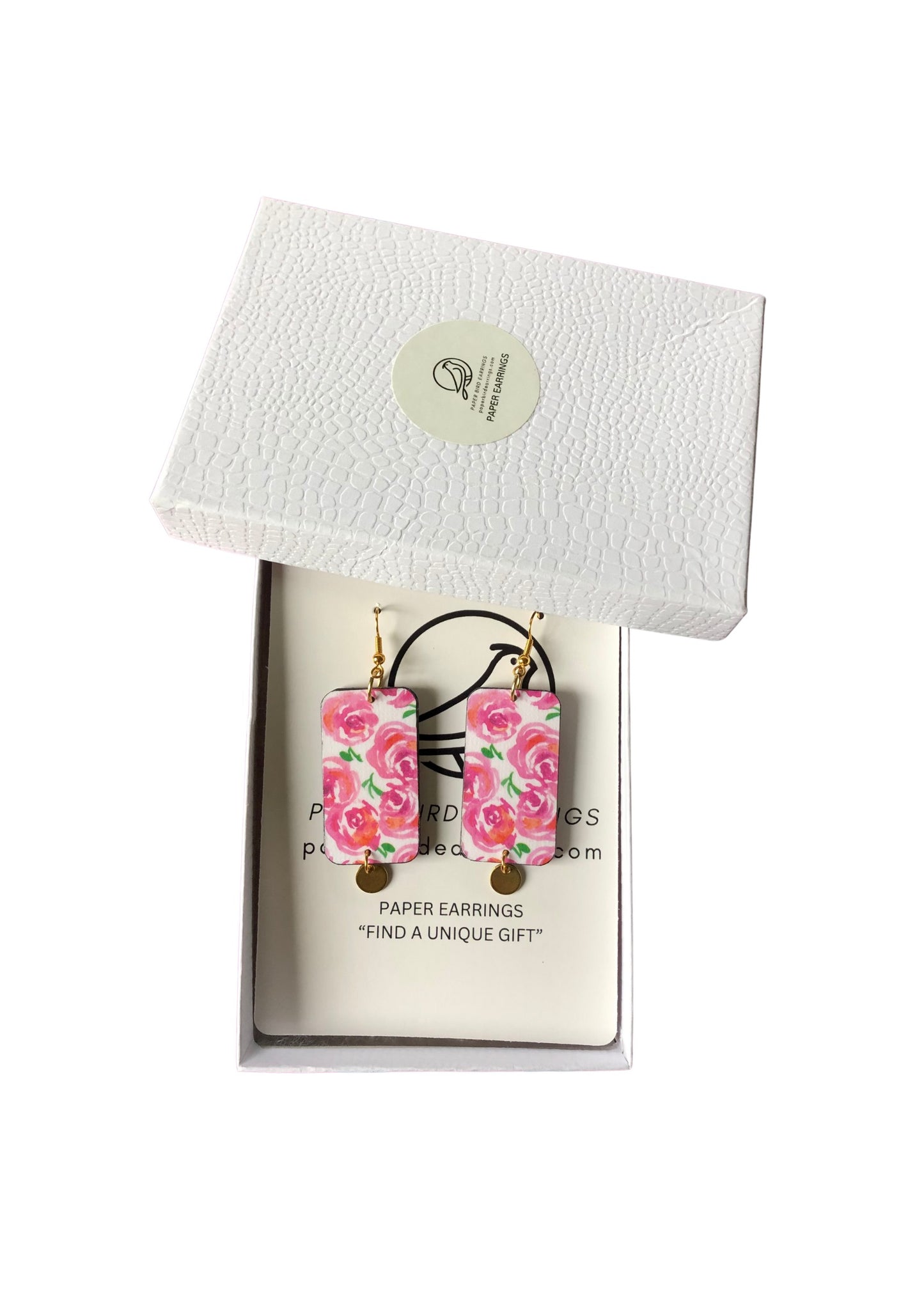 Floral paper earrings in a white box with a brand label.