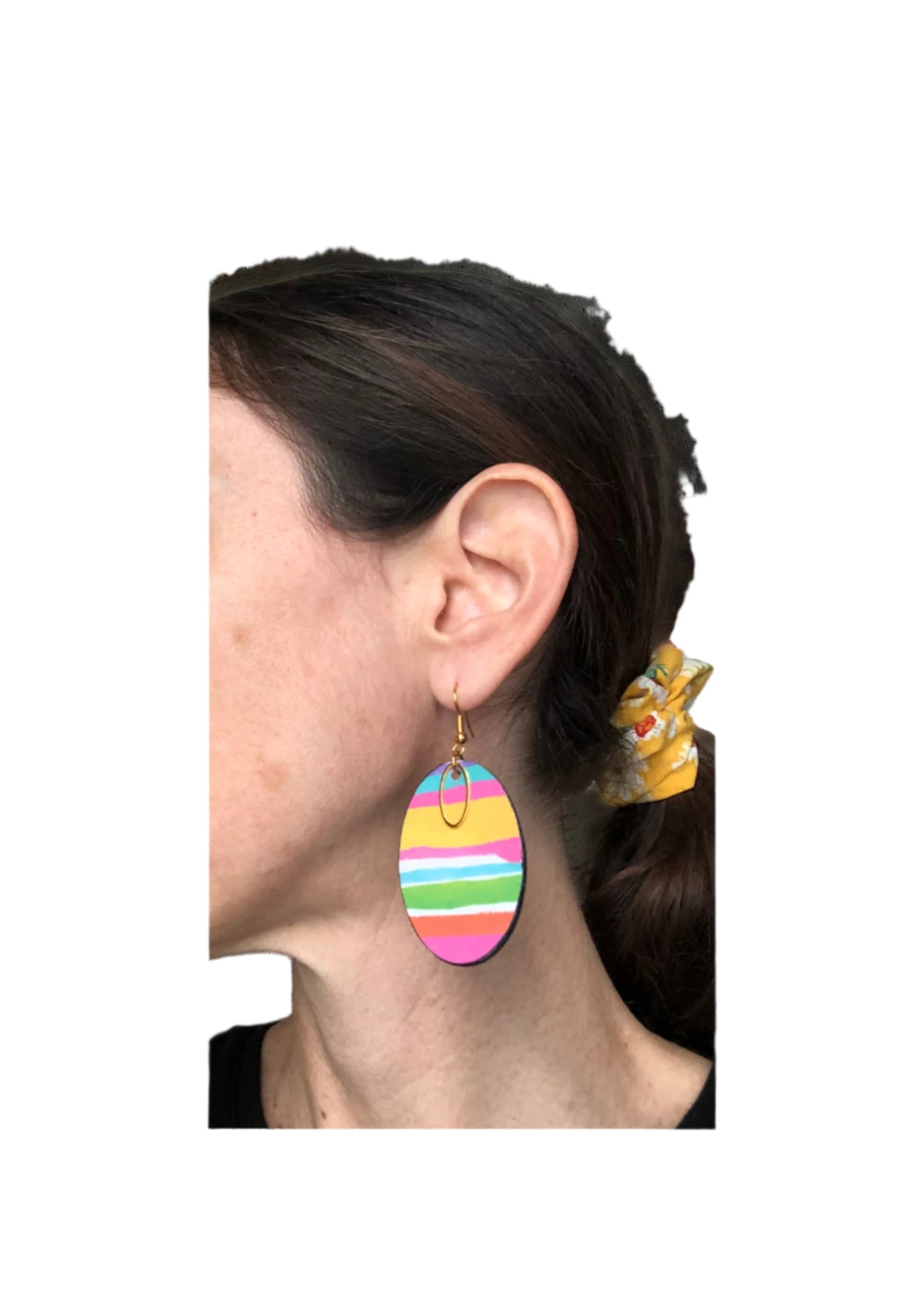 Colorful striped earrings worn by a person with a plain background