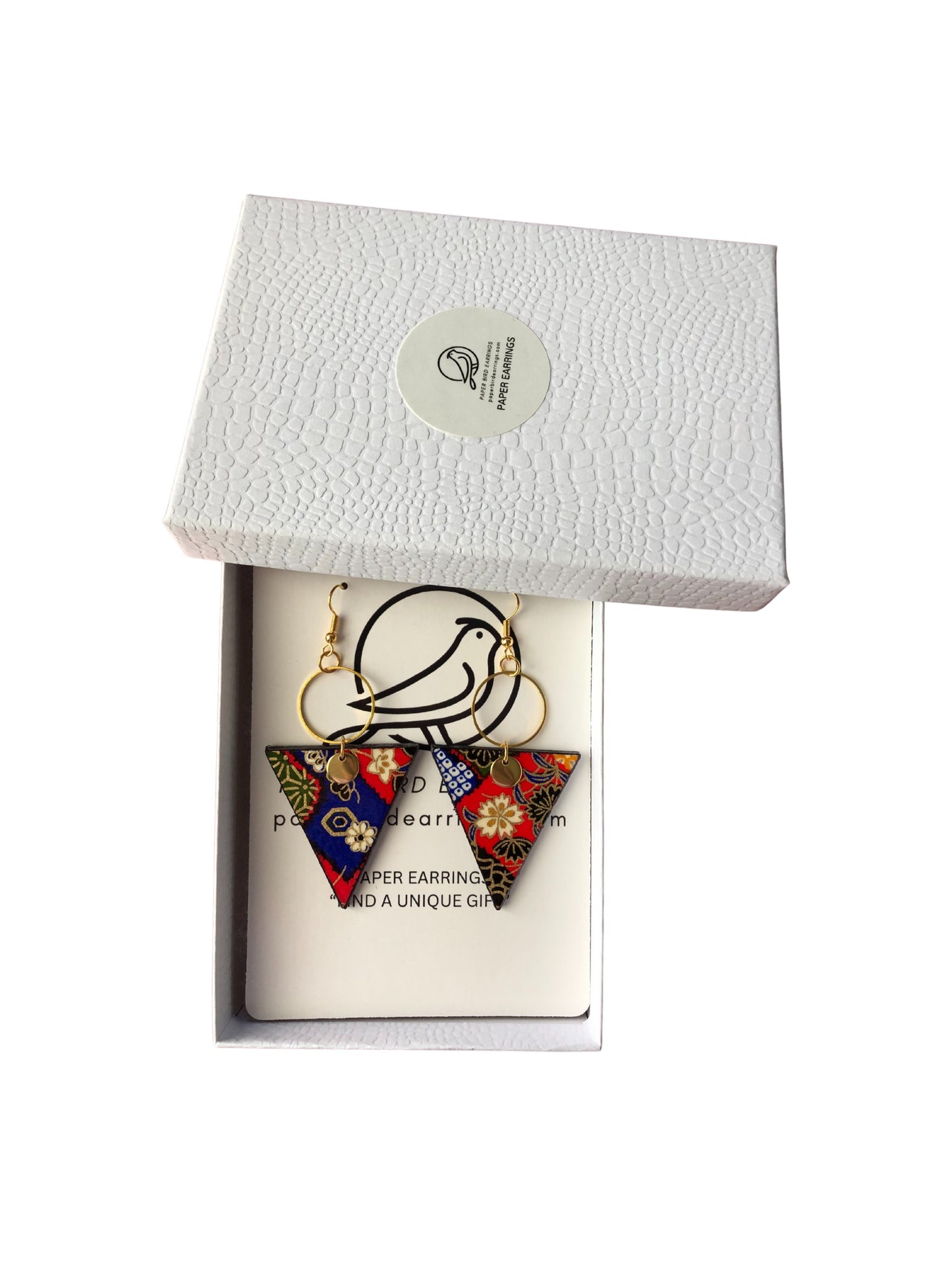 Triangular earrings with floral designs in a white box packaging.