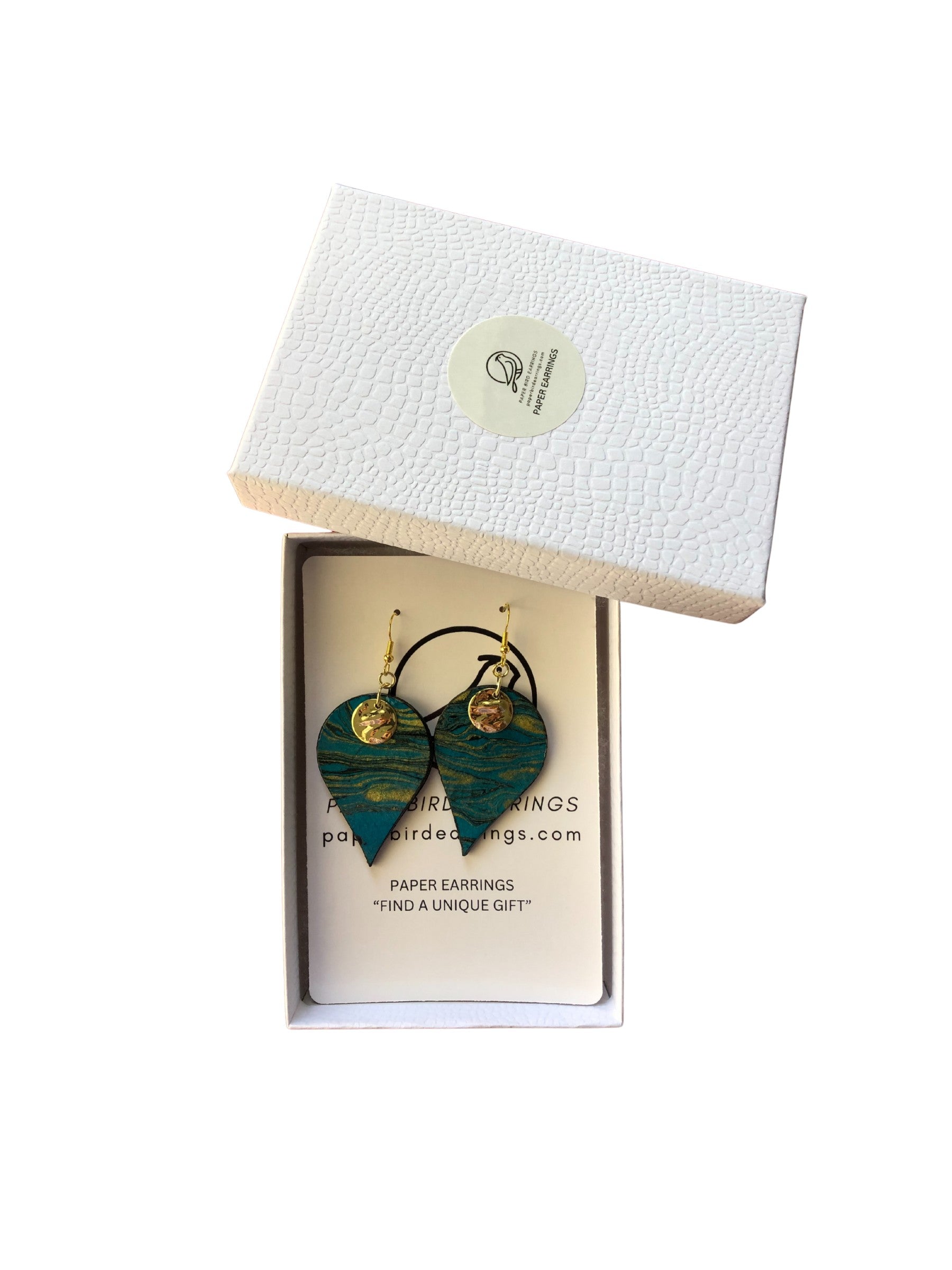 Green heart-shaped earrings in a branded box on a white background