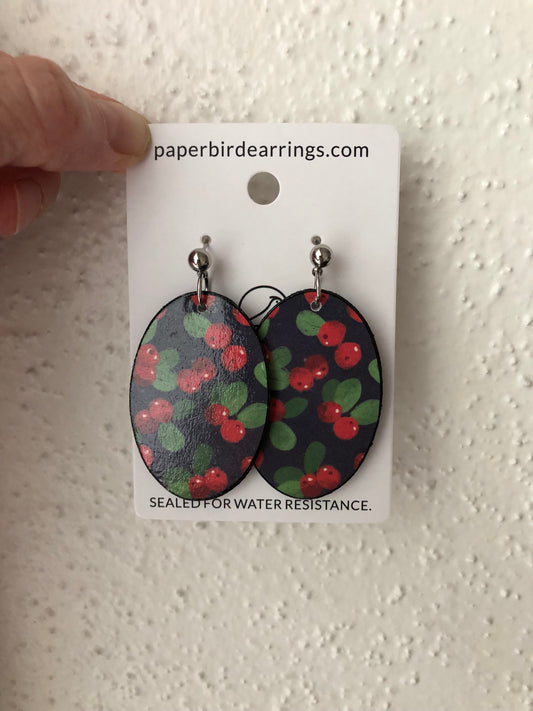 Cherry-patterned paper earrings on a oval design