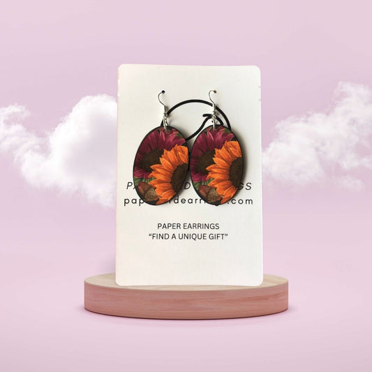 Earrings on a card with a pink background