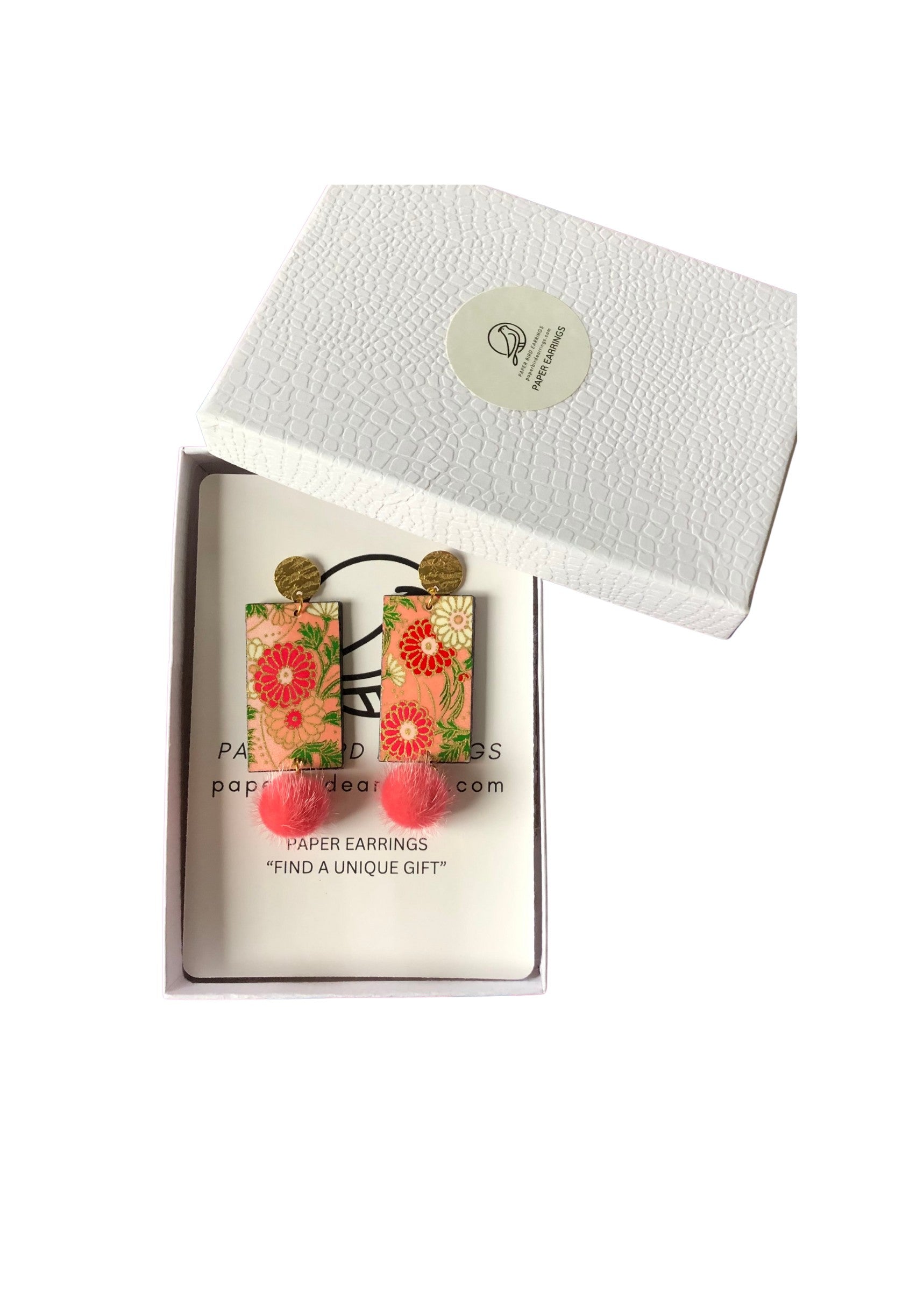 Floral earrings in a white box with a visible brand label.