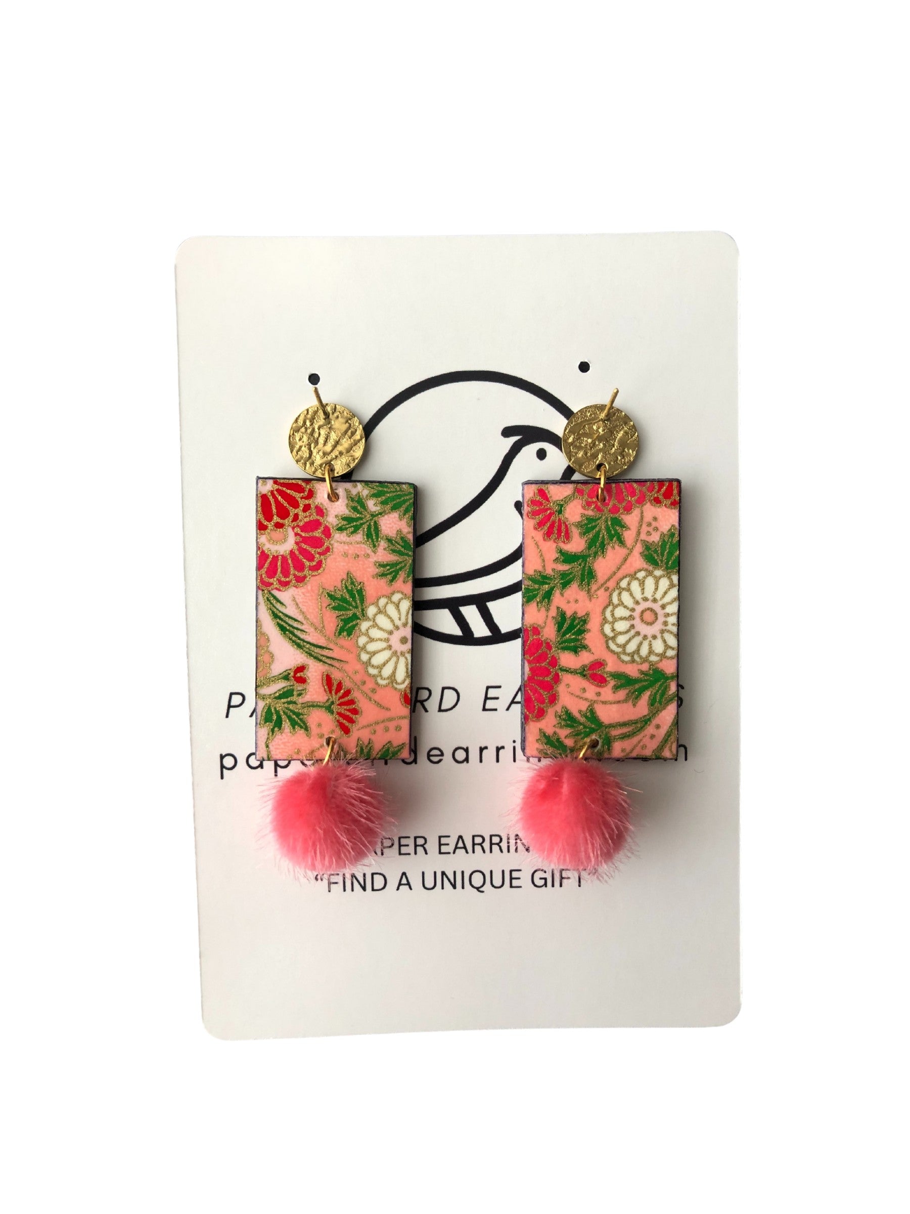 Floral patterned earrings with pom-pom details on a white card