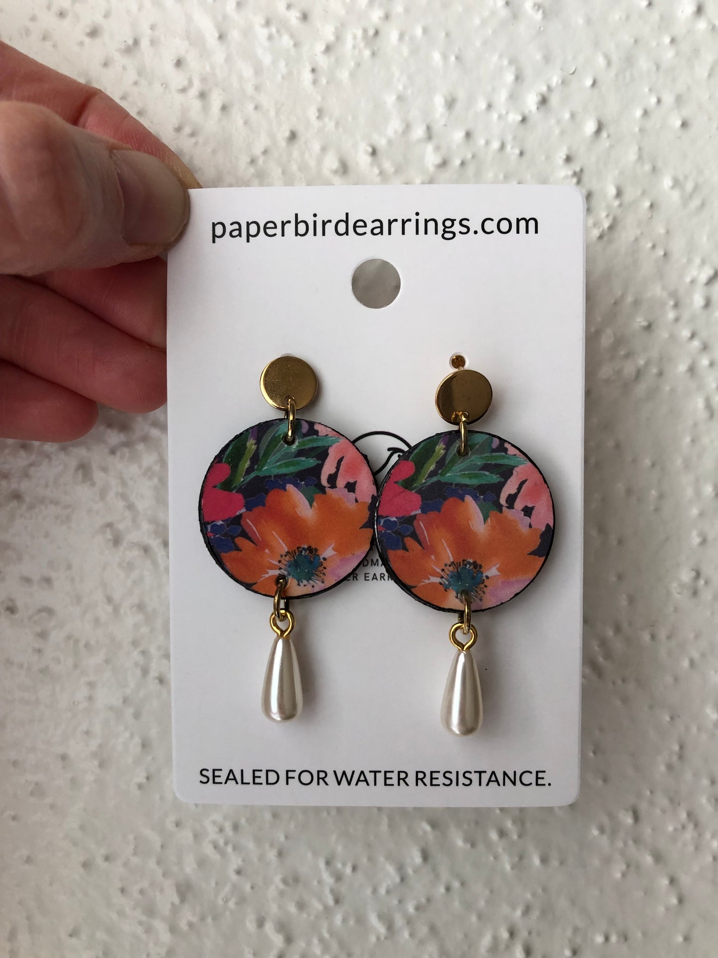 small round paper earrings with an orange flower handmade paper earrings