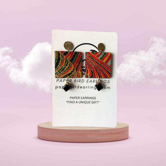 Earring card with colorful paper bird earrings on a pink background
