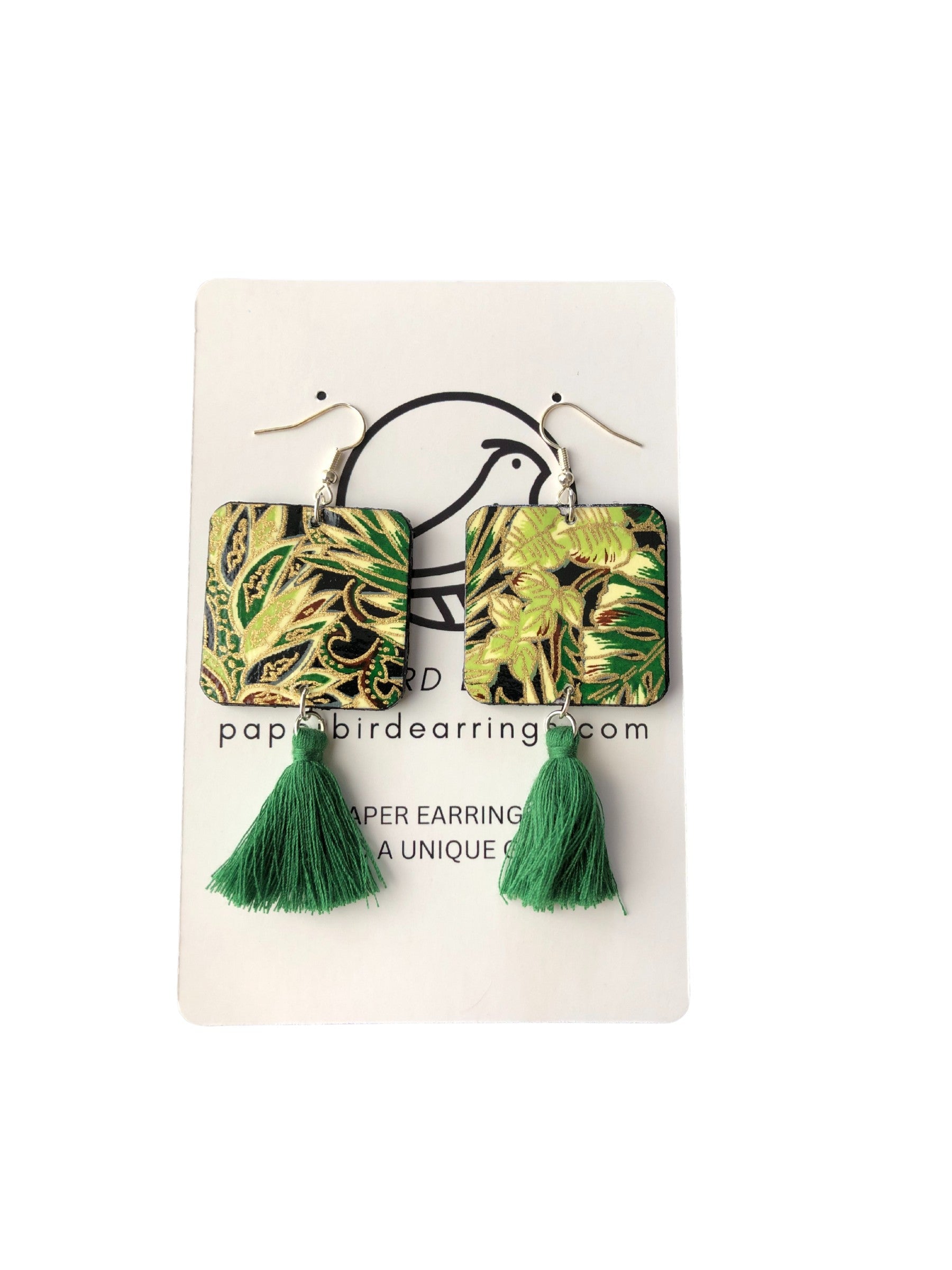 Pair of earrings with green tassels on a white card