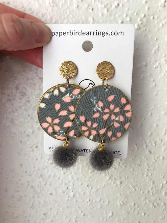 handmade paper earrings with pink Sakura design on grey paper with grey pom poms paper bird earrings