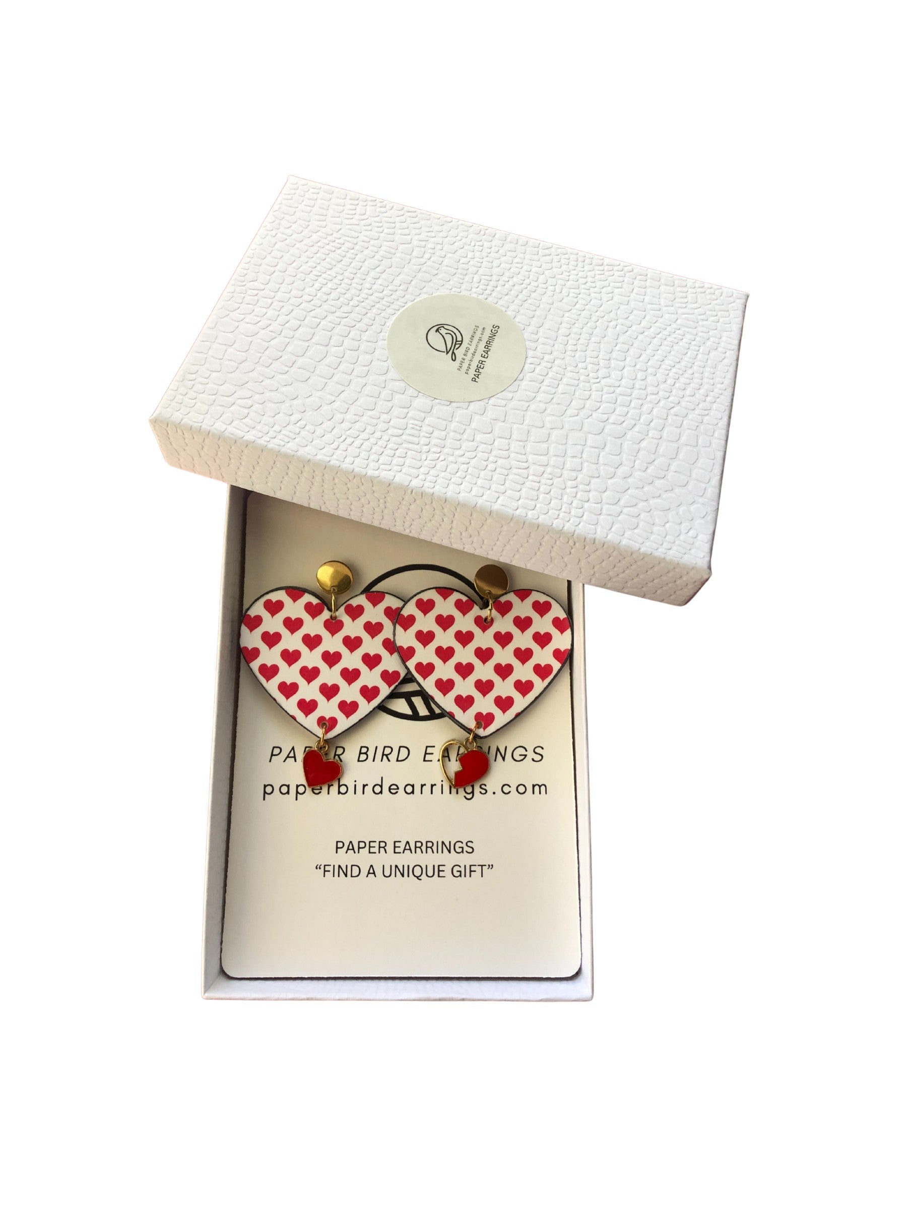 Heart-shaped earrings in a branded box on a white background