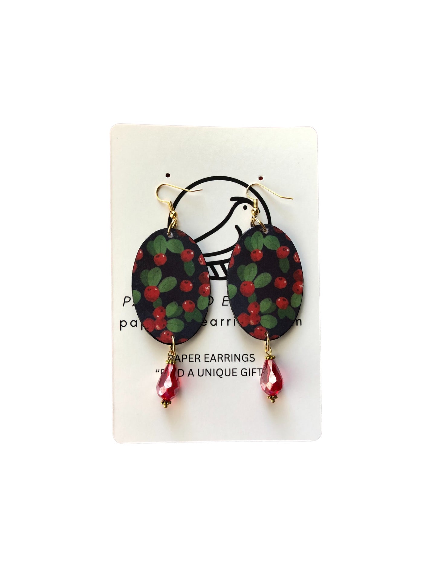 Pair of earrings with green and red floral design on a white card