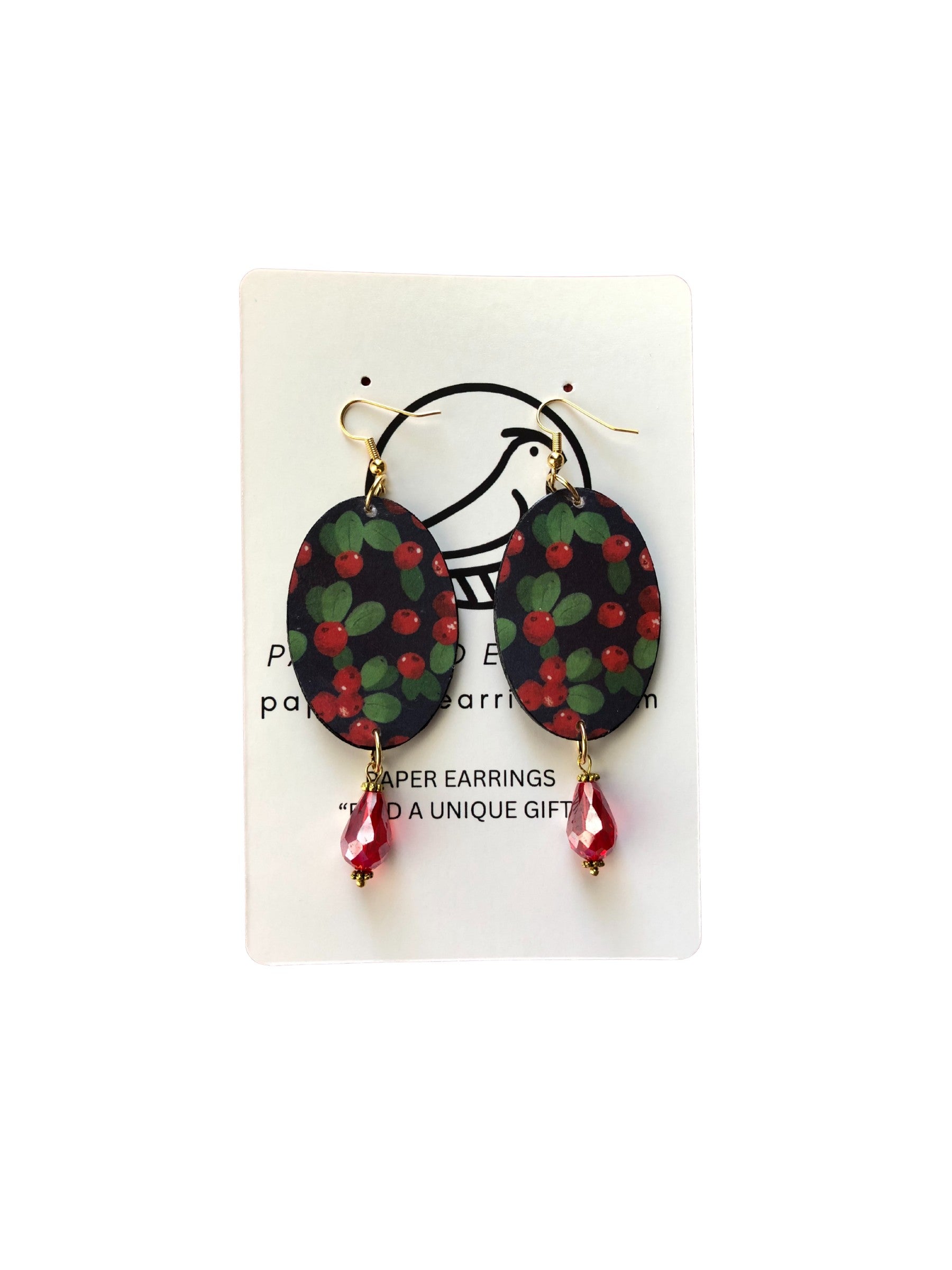 Pair of earrings with green and red floral design on a white card