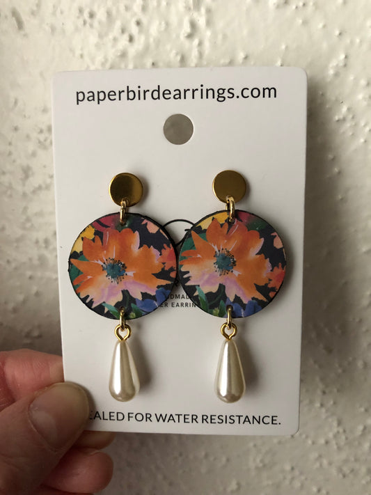 small round paper earrings with a pink flower design and pearls